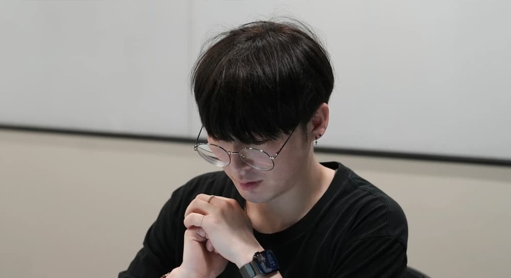 베스핀글로벌 AI Expert Team 안원빈 팀장이 두 손을 모으고 생각에 잠긴 채 노트북 앞에 앉아 있는 모습이다.